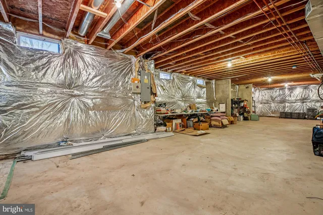 a front view of a building with cars parked