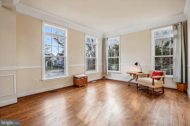 a living room with furniture a rug and a window