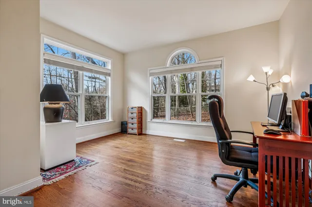 a bedroom with furniture and a large window