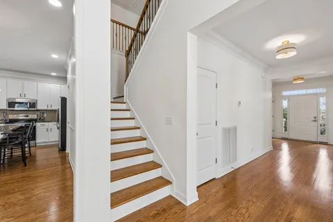 a view of entryway and hall with wooden floor