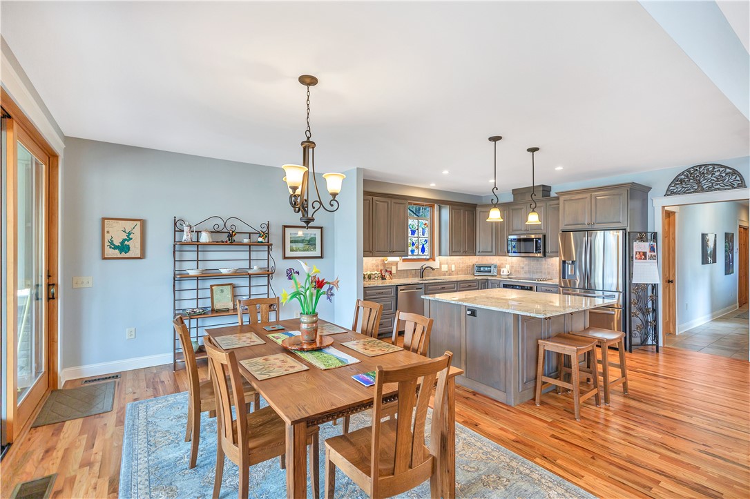 10 Admiral Lane Salem, SC 29676 - Photo 11 of 43 This spacious kitchen and dining area features warm hardwood flooring, elegant granite countertops, and modern stainless steel appliances.