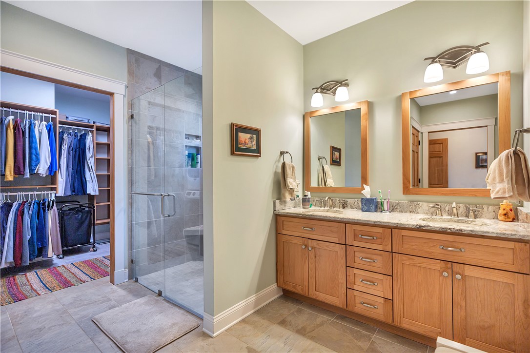 10 Admiral Lane Salem, SC 29676 - Photo 22 of 43 This spacious bathroom offers a double vanity and a glass-enclosed shower, complemented by a walk-in closet.