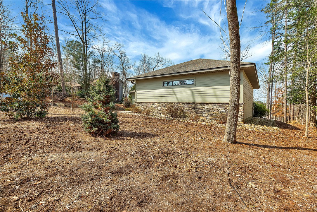10 Admiral Lane Salem, SC 29676 - Photo 35 of 43 This residence features a blend of horizontal siding and stone, nestled among natural woodlands.