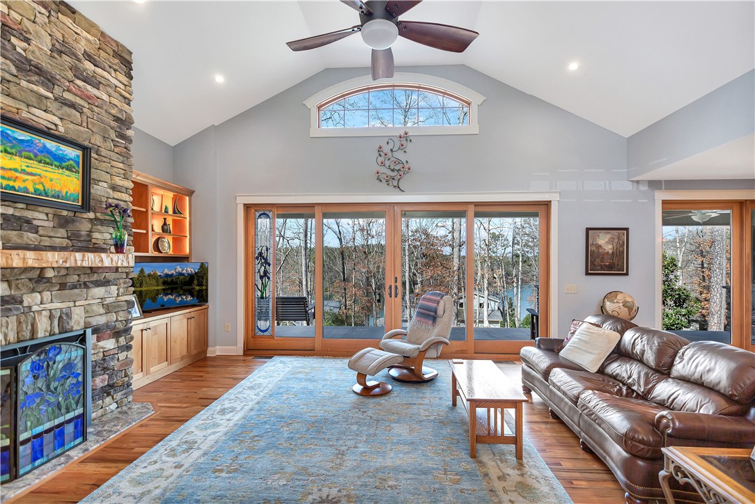 10 Admiral Lane Salem, SC 29676 - Photo 4 of 43 This living room features expansive windows offering serene lake and forest views.