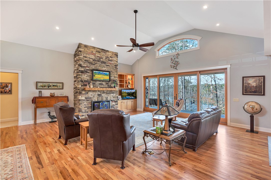 10 Admiral Lane Salem, SC 29676 - Photo 6 of 43 This bright living space features wood floors, a soaring vaulted ceiling, and expansive glass doors opening to nature.