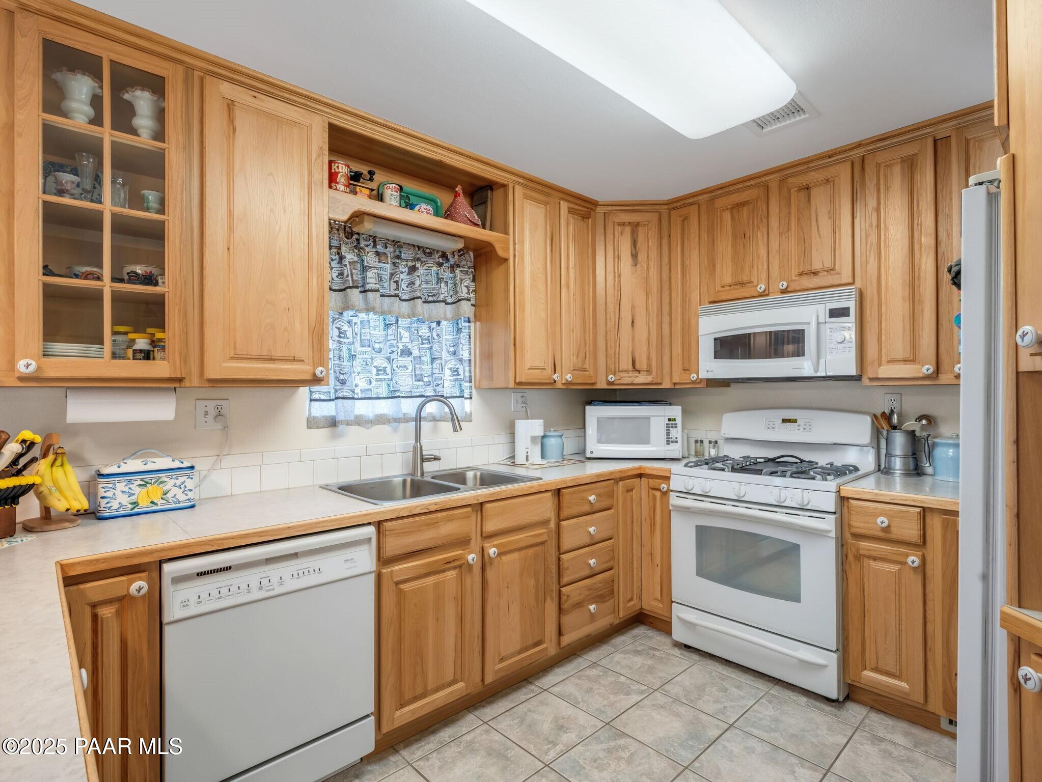 2710 Ridge Road Prescott, AZ 86301 - Photo 14 of 32 a kitchen with stainless steel appliances granite countertop a sink dishwasher stove and cabinets