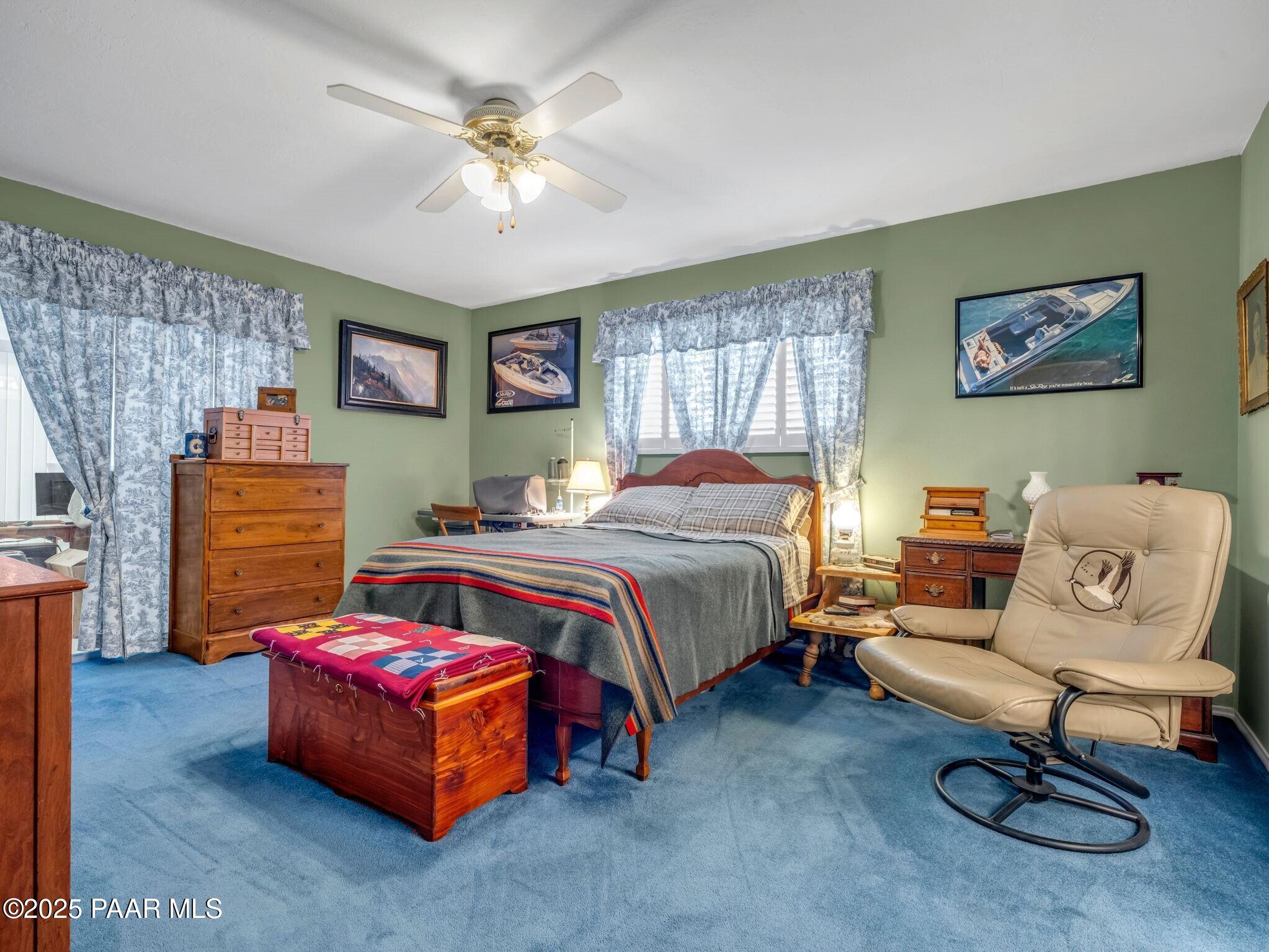 2710 Ridge Road Prescott, AZ 86301 - Photo 16 of 32 a bedroom with a bed and a chandelier