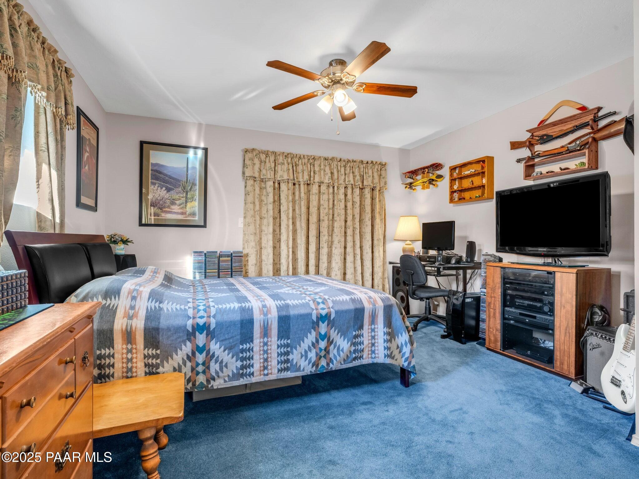 2710 Ridge Road Prescott, AZ 86301 - Photo 20 of 32 a bedroom with a bed and a flat screen tv