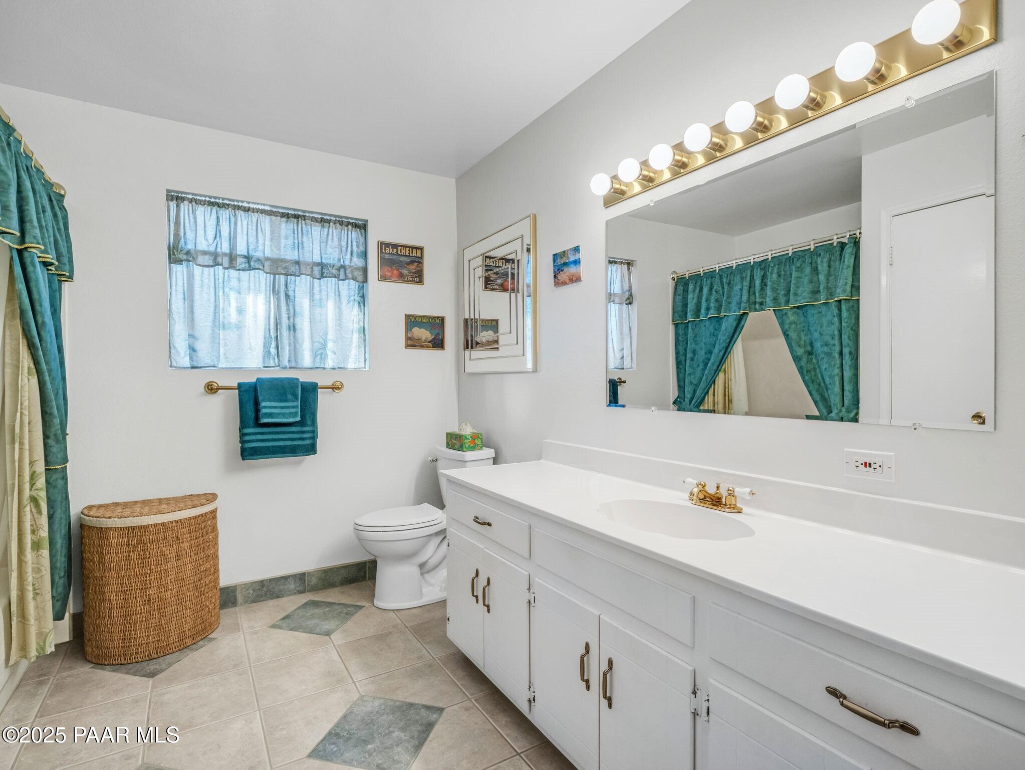 2710 Ridge Road Prescott, AZ 86301 - Photo 21 of 32 a bathroom with a double vanity sink a toilet and a mirror