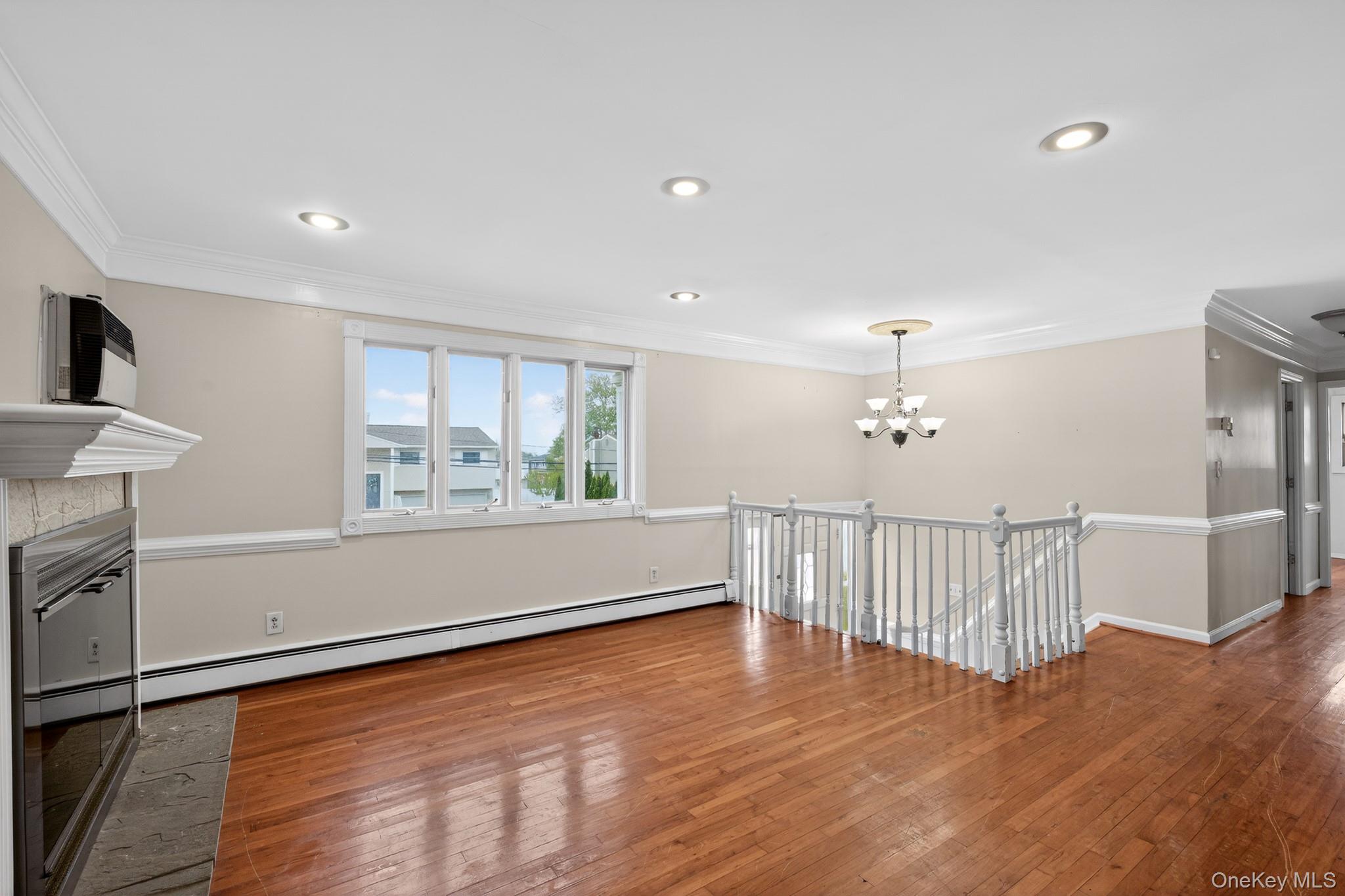 138 Spring Street Massapequa, NY 11758 - Photo 4 of 45 a view of livingroom with furniture window and wooden floor