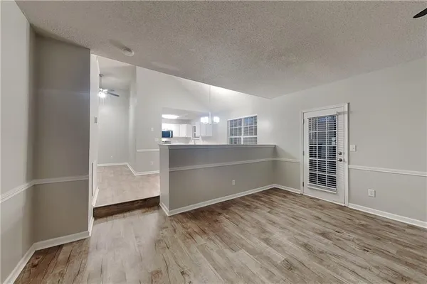 a view of a room with wooden floor and windows