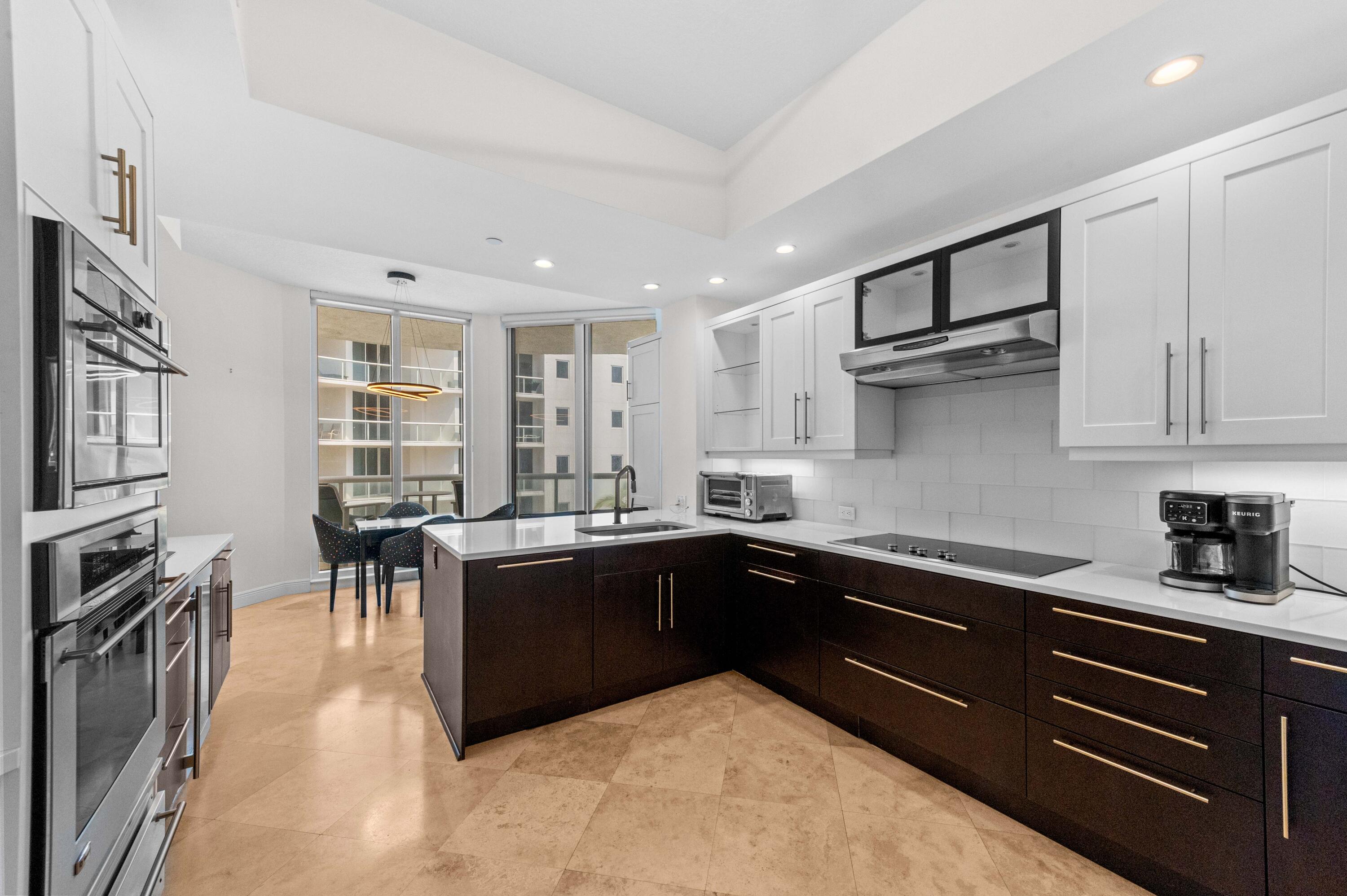4600 North Ocean Drive, Unit 605 Riviera Beach, FL 33404 - Photo 11 of 65 a kitchen with stainless steel appliances granite countertop a sink dishwasher stove and cabinets