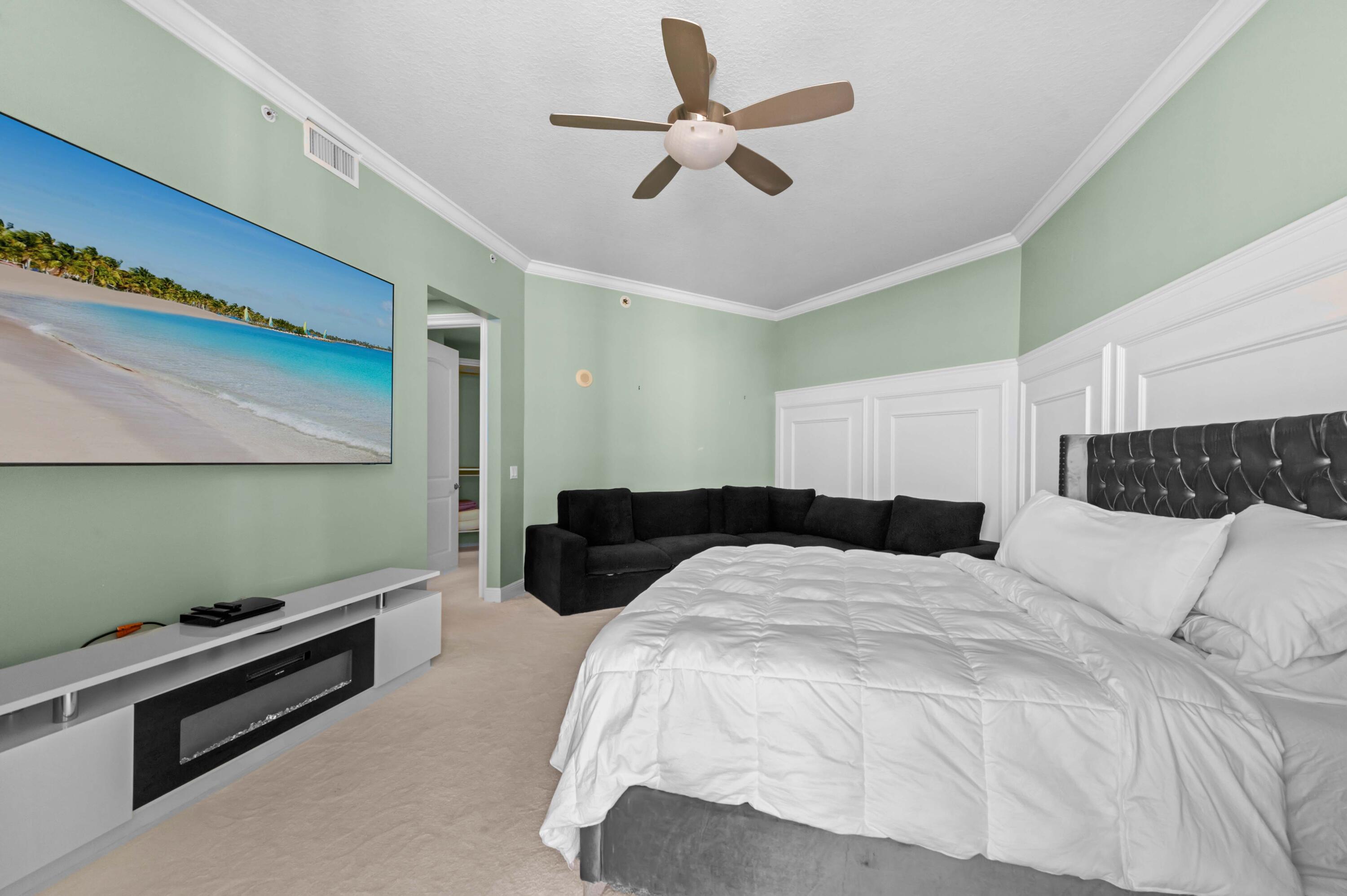 4600 North Ocean Drive, Unit 605 Riviera Beach, FL 33404 - Photo 19 of 65 a bedroom with a bed and a ceiling fan