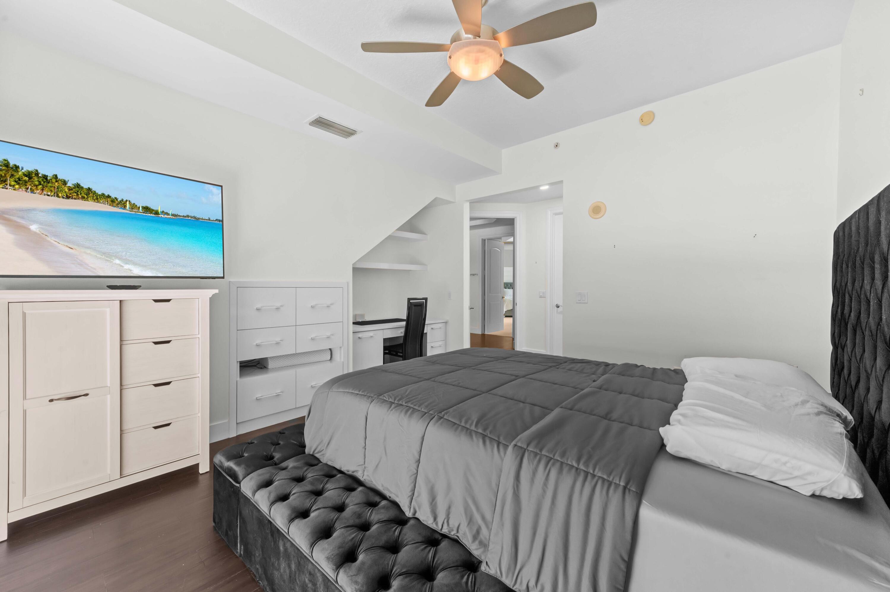 4600 North Ocean Drive, Unit 605 Riviera Beach, FL 33404 - Photo 29 of 65 a bedroom with a bed and a cabinets