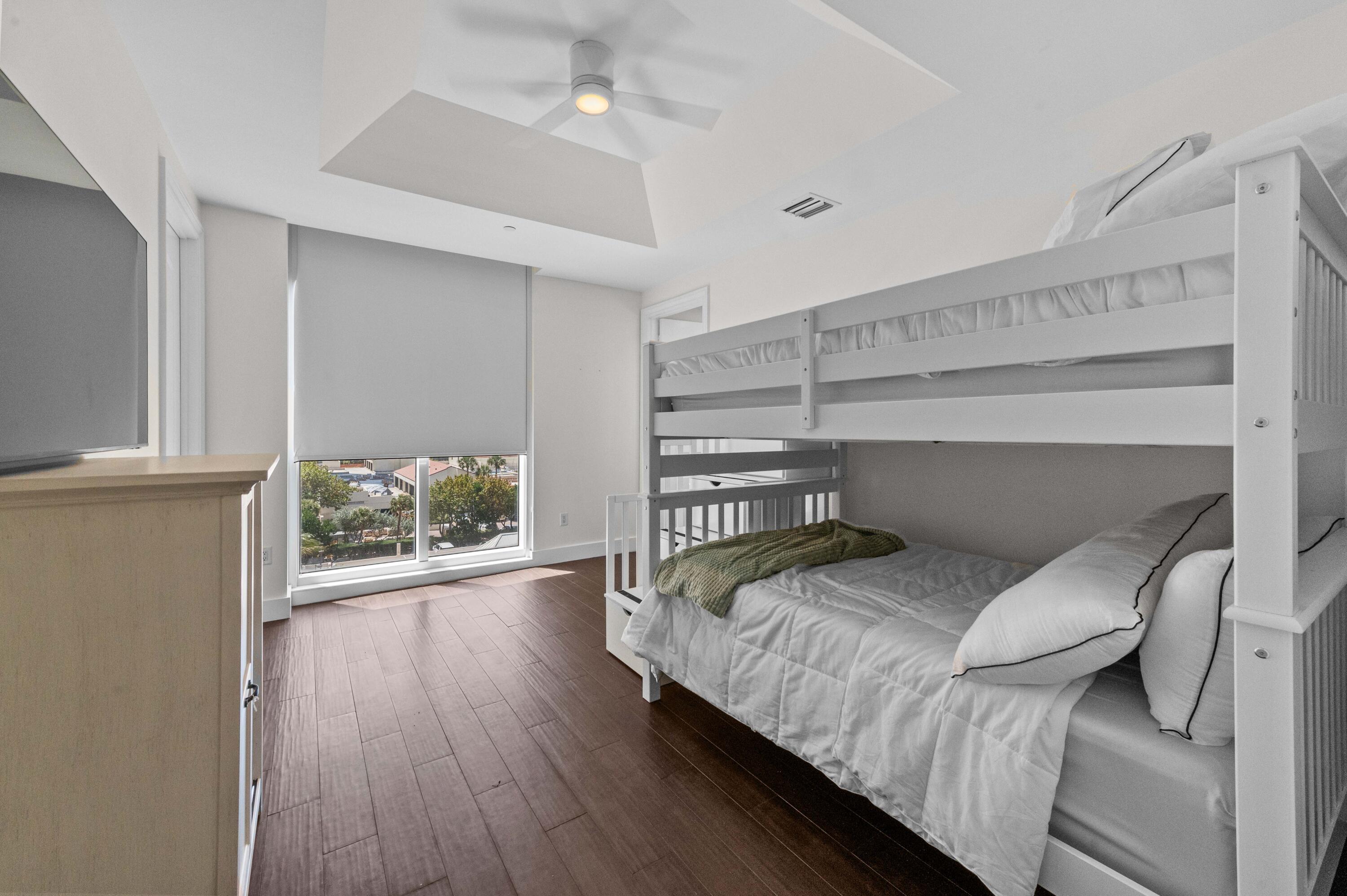 4600 North Ocean Drive, Unit 605 Riviera Beach, FL 33404 - Photo 31 of 65 a bedroom with a bed and a wooden floor