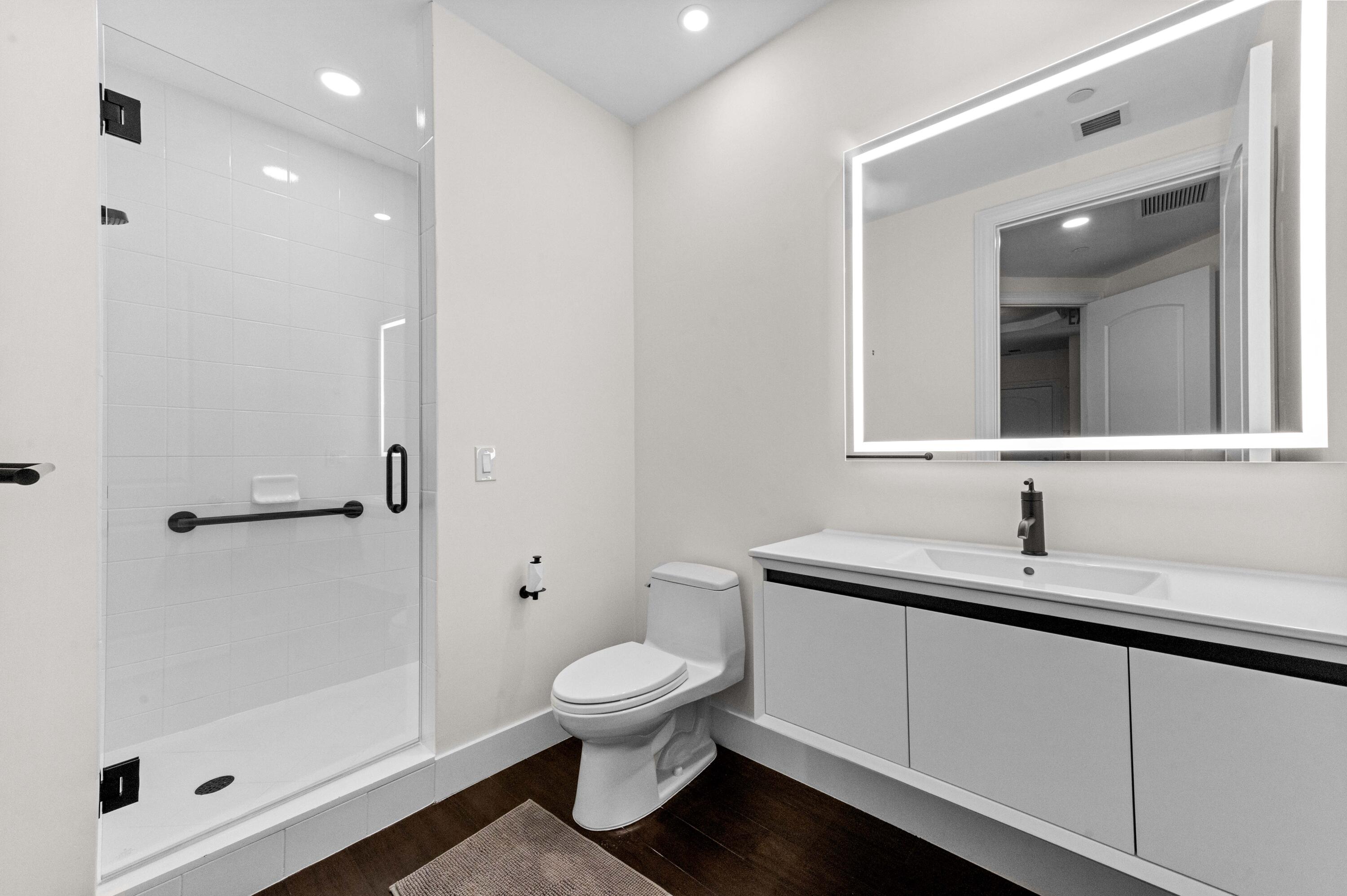 4600 North Ocean Drive, Unit 605 Riviera Beach, FL 33404 - Photo 33 of 65 a bathroom with a toilet sink and shower