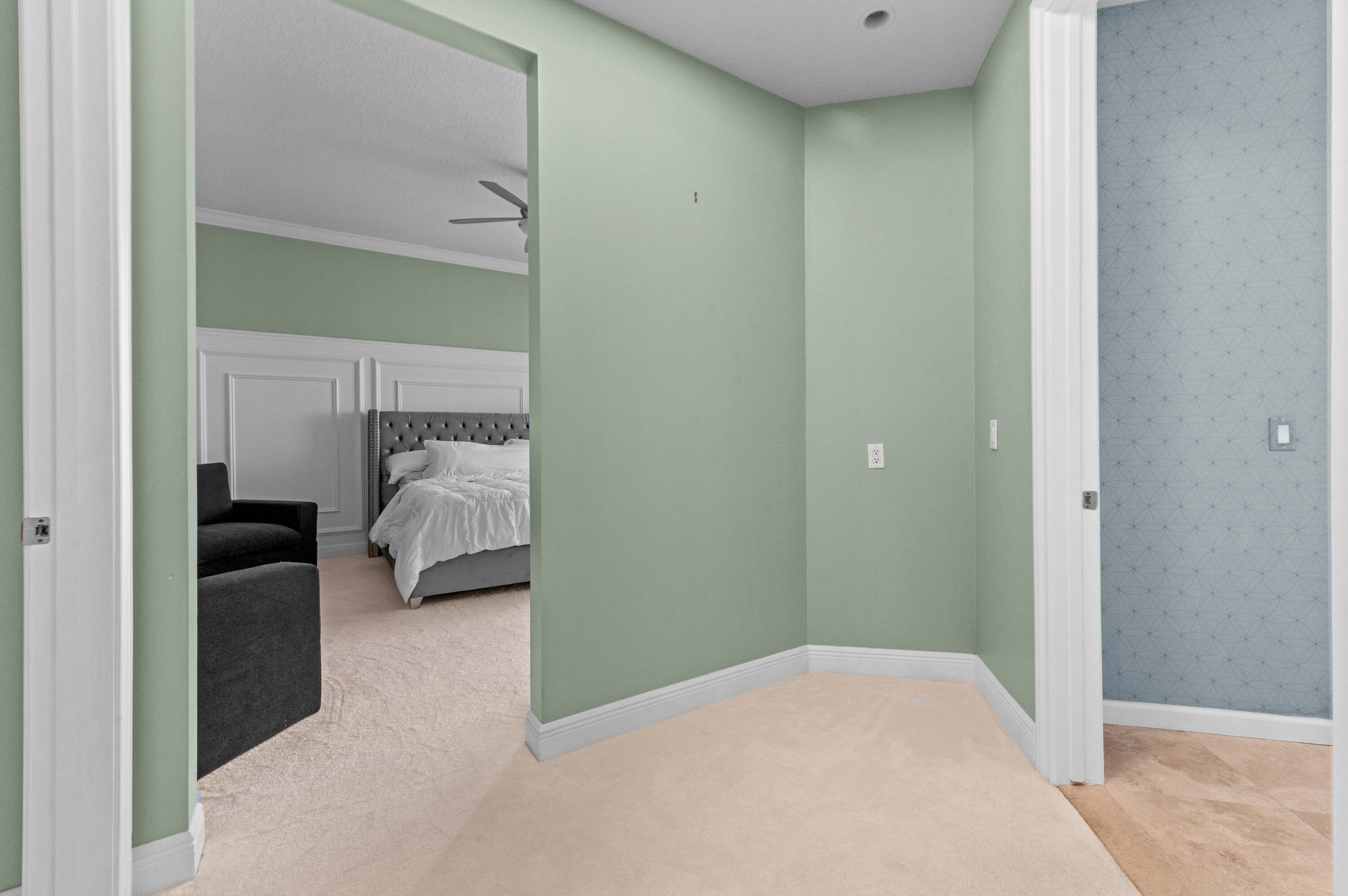 4600 North Ocean Drive, Unit 605 Riviera Beach, FL 33404 - Photo 34 of 65 a bedroom with a bed and a view of en suite bathroom