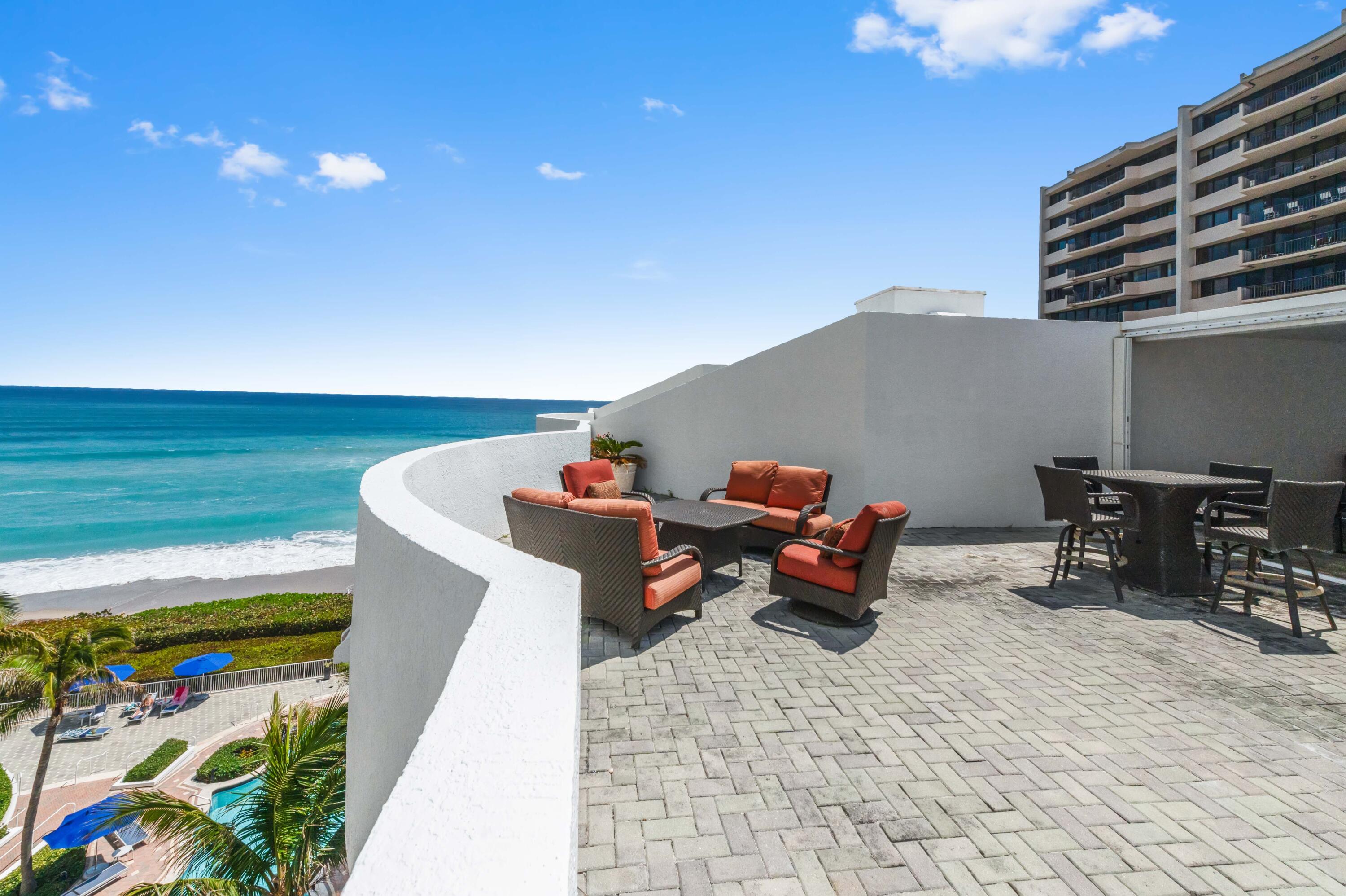 4600 North Ocean Drive, Unit 605 Riviera Beach, FL 33404 - Photo 4 of 65 a roof deck with table and chairs and potted plants
