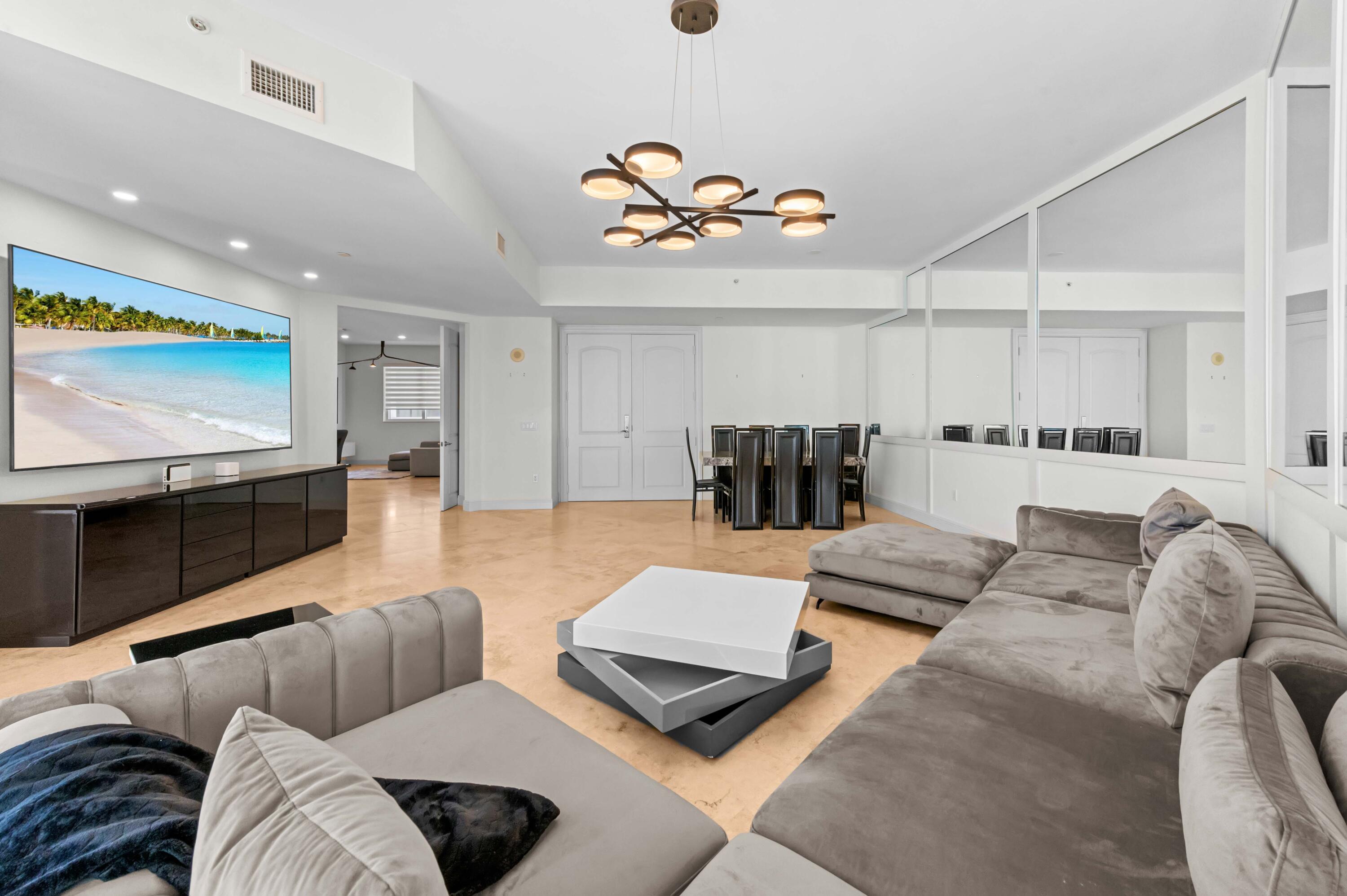 4600 North Ocean Drive, Unit 605 Riviera Beach, FL 33404 - Photo 5 of 65 a living room with furniture and a flat screen tv