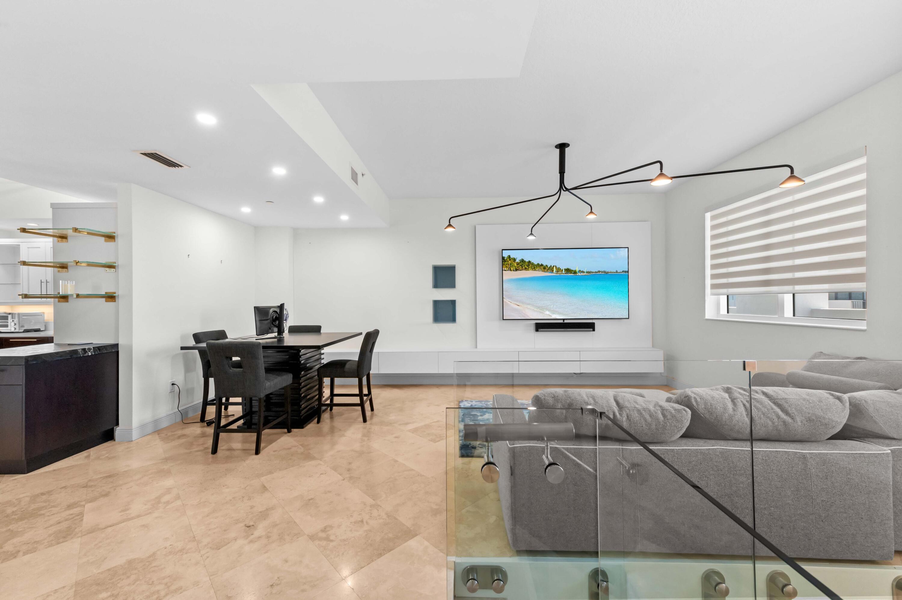 4600 North Ocean Drive, Unit 605 Riviera Beach, FL 33404 - Photo 7 of 65 a living room with furniture and a flat screen tv