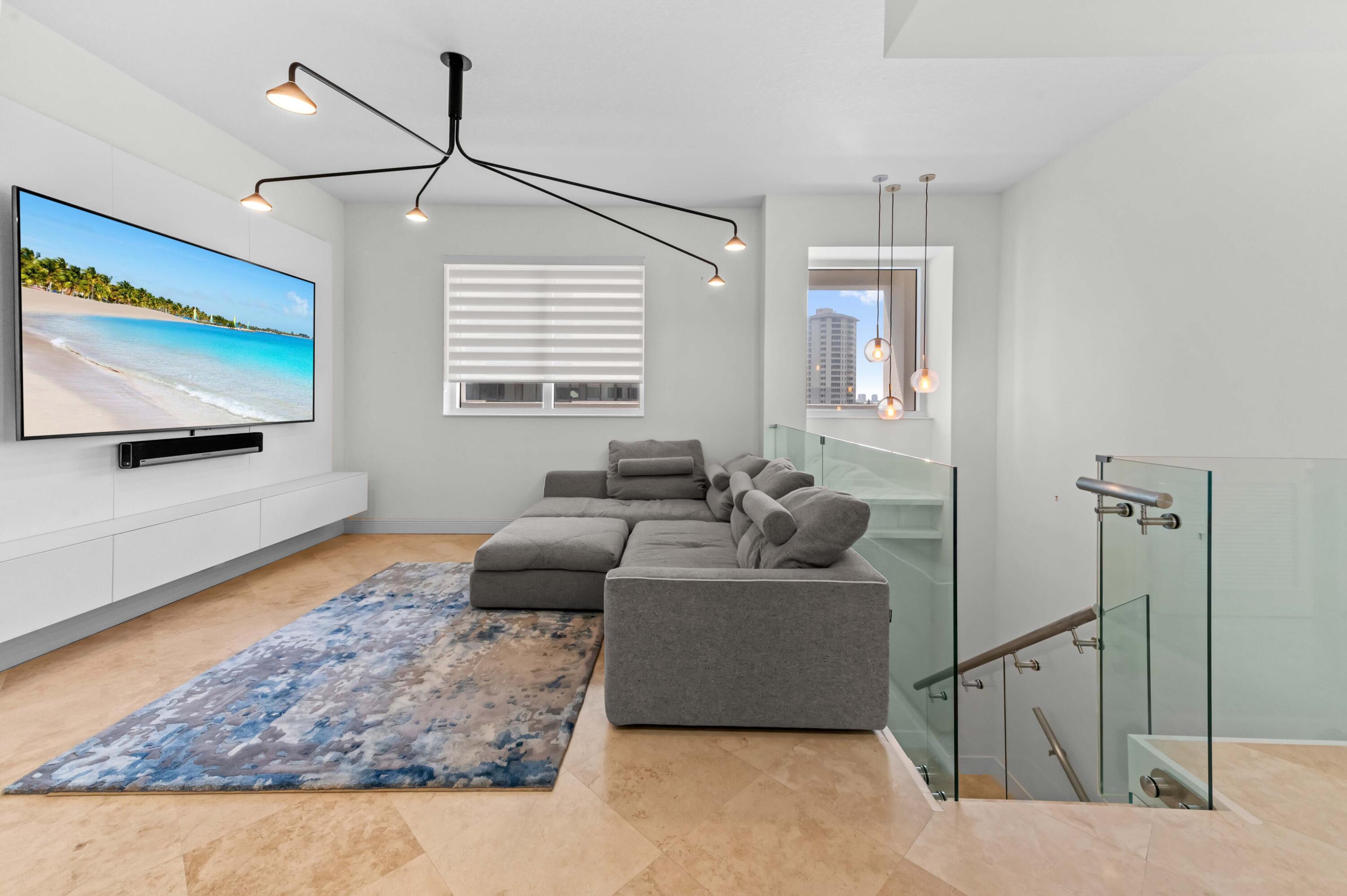 4600 North Ocean Drive, Unit 605 Riviera Beach, FL 33404 - Photo 8 of 65 a living room with furniture and a flat screen tv