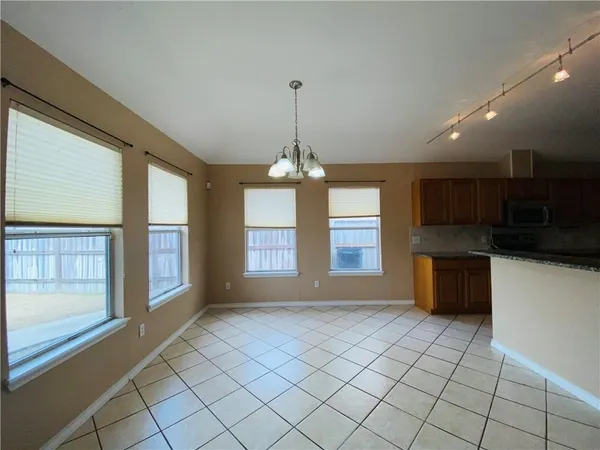 a view of an empty room with a kitchen