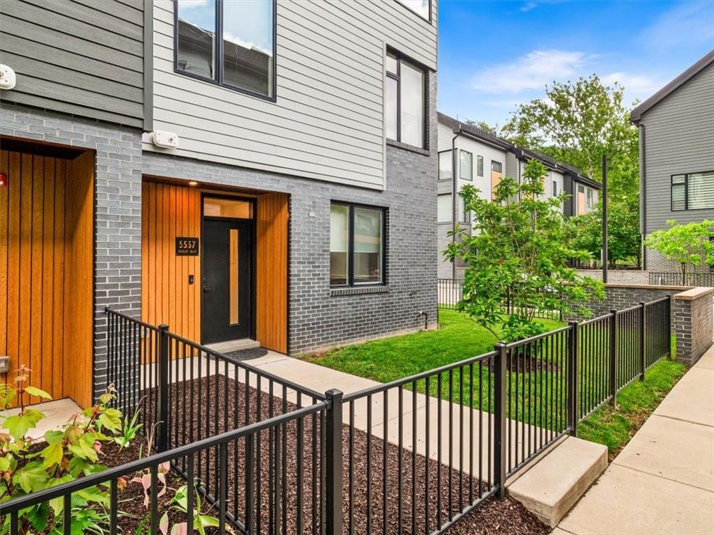 a view of a house with a wooden fence
