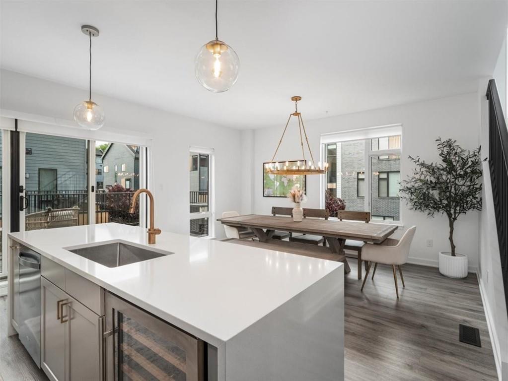 5557 Berlin Way Pittsburgh, PA 15201 - Photo 12 of 34 a kitchen with a sink a counter and chairs
