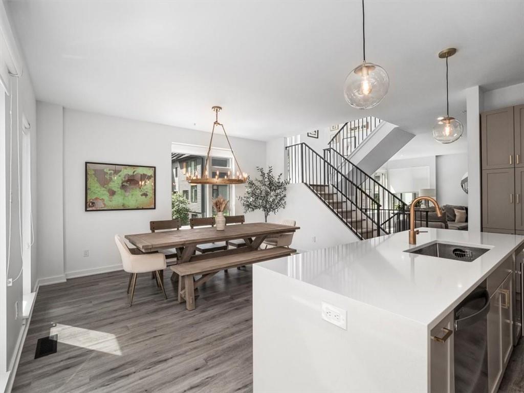5557 Berlin Way Pittsburgh, PA 15201 - Photo 13 of 34 a view of a dining room and livingroom with furniture wooden floor a chandelier