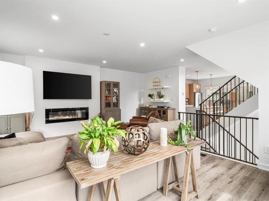 5557 Berlin Way Pittsburgh, PA 15201 - Photo 20 of 34 a living room with fireplace furniture dining table and a flat screen tv