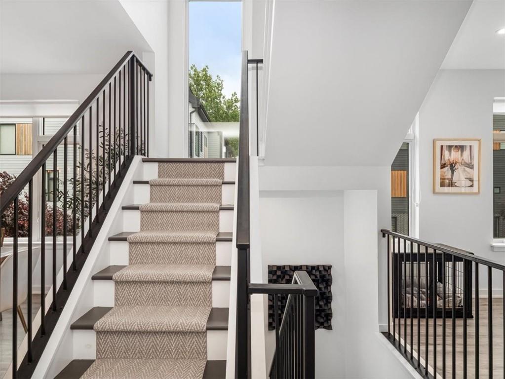 5557 Berlin Way Pittsburgh, PA 15201 - Photo 22 of 34 a view of staircase with lots of frames on wall and a window