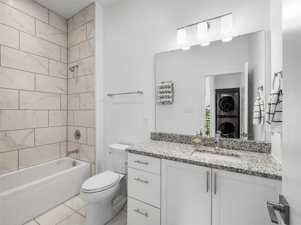 5557 Berlin Way Pittsburgh, PA 15201 - Photo 29 of 34 a bathroom with a granite countertop sink toilet mirror and bathtub