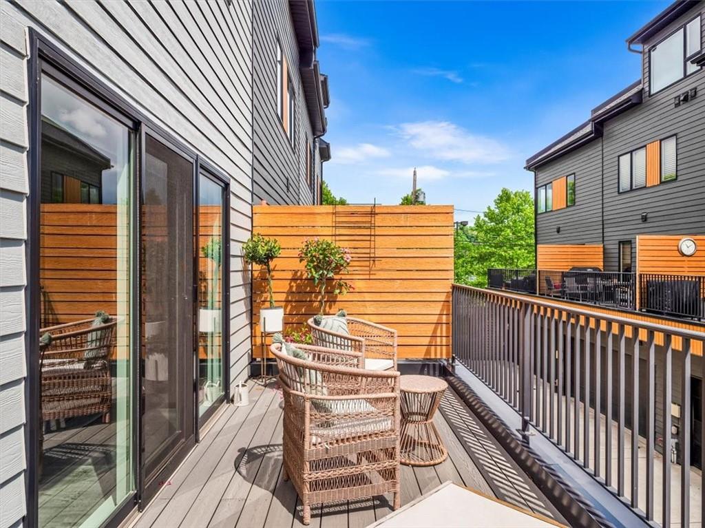 5557 Berlin Way Pittsburgh, PA 15201 - Photo 30 of 34 a view of a balcony with floor to ceiling window wooden floor and brick wall