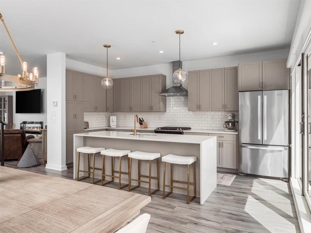 5557 Berlin Way Pittsburgh, PA 15201 - Photo 9 of 34 a kitchen with stainless steel appliances a sink stove and refrigerator