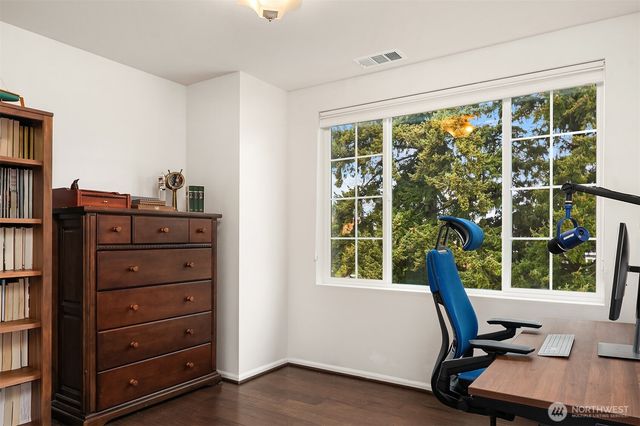 a view of a workspace with furniture and windows