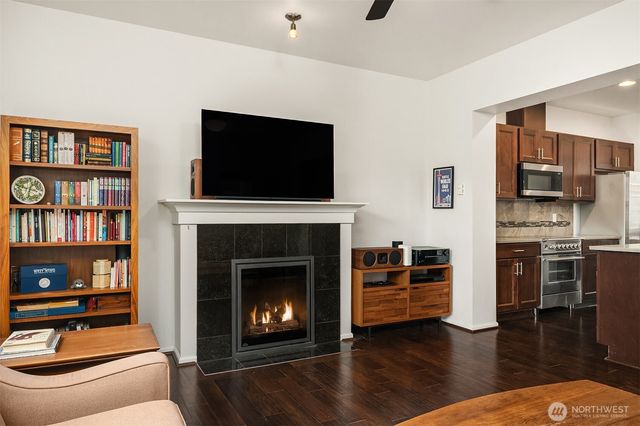 a living room with furniture fireplace and flat screen tv