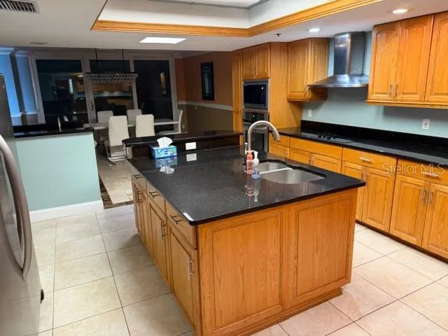a kitchen with stainless steel appliances granite countertop a sink counter space and cabinets