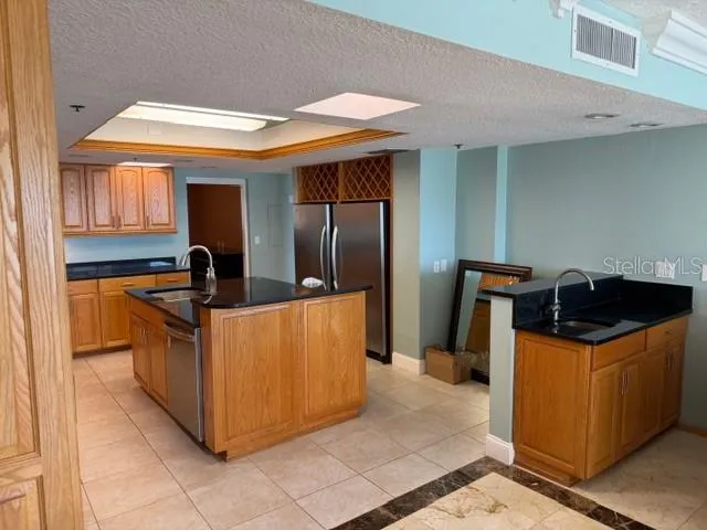 a kitchen with stainless steel appliances granite countertop a stove a refrigerator and a dishwasher