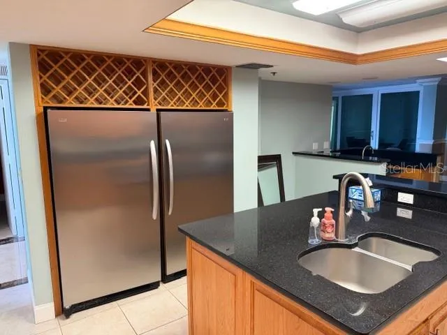 a kitchen with a sink and a refrigerator