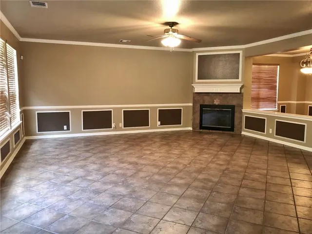 a big room with windows and fireplace