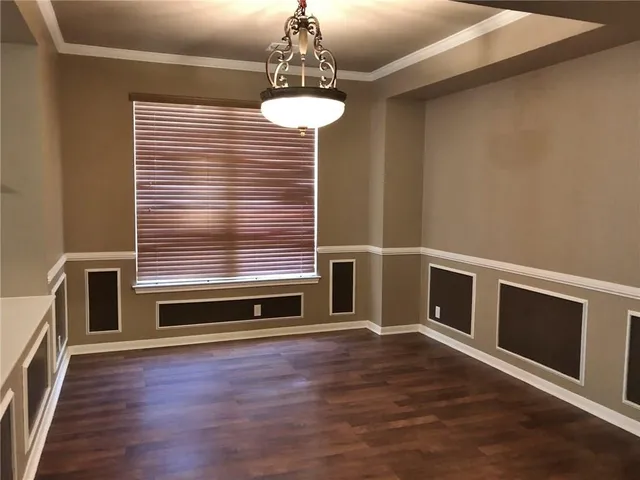 a view of room with wooden floor and window