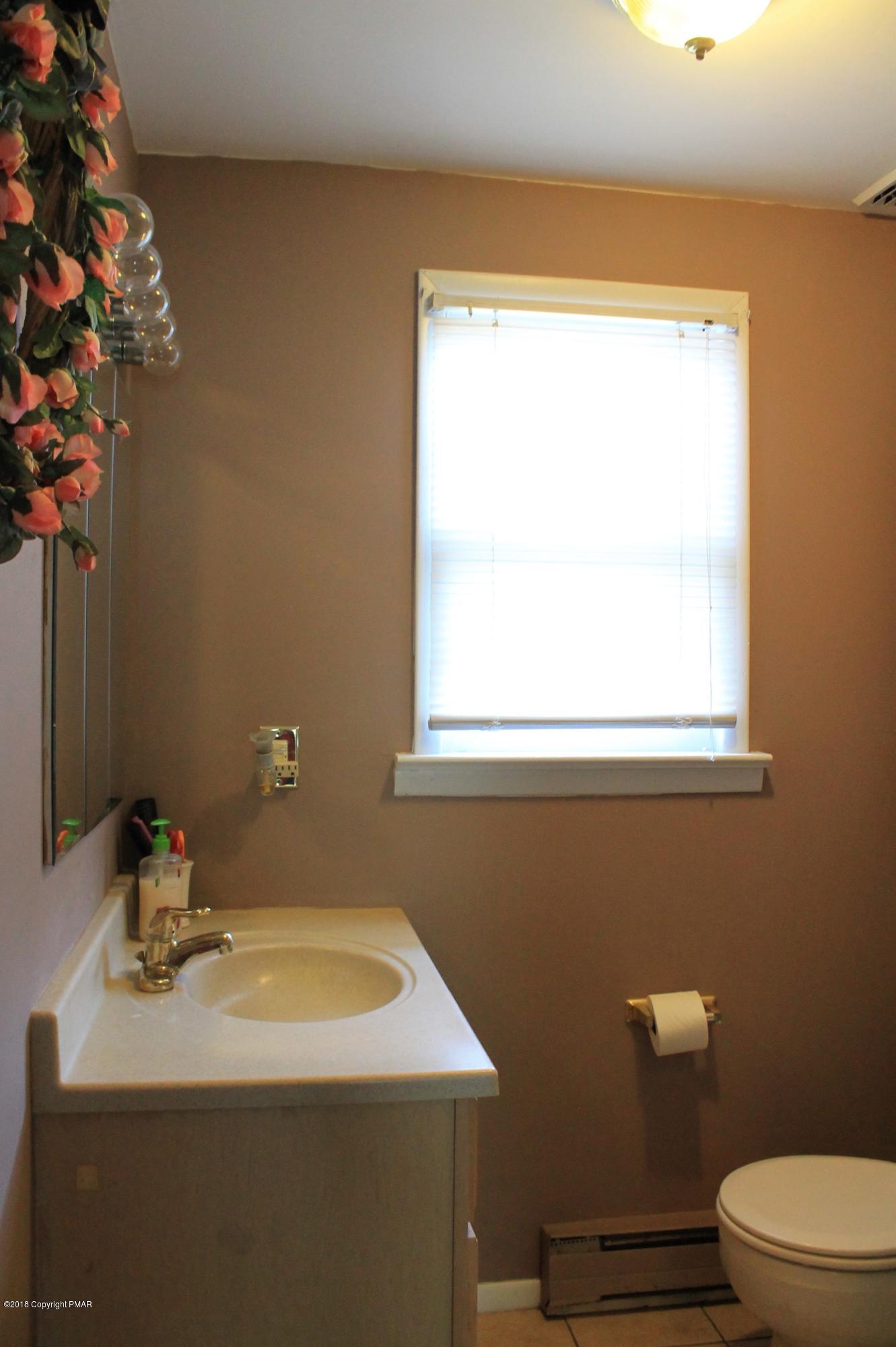 1182 Mattioli Road Bartonsville, PA 18321 - Photo 8 of 19 a bathroom with a sink a toilet and a mirror