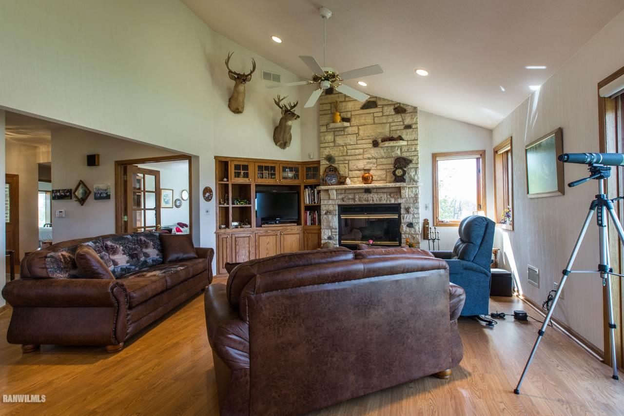 5920 East Townsend Road Stockton, IL 61085 - Photo 3 of 10 a living room with furniture a fireplace and a flat screen tv