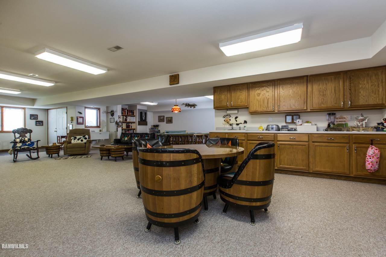 5920 East Townsend Road Stockton, IL 61085 - Photo 7 of 10 a kitchen with a sink a counter and chairs