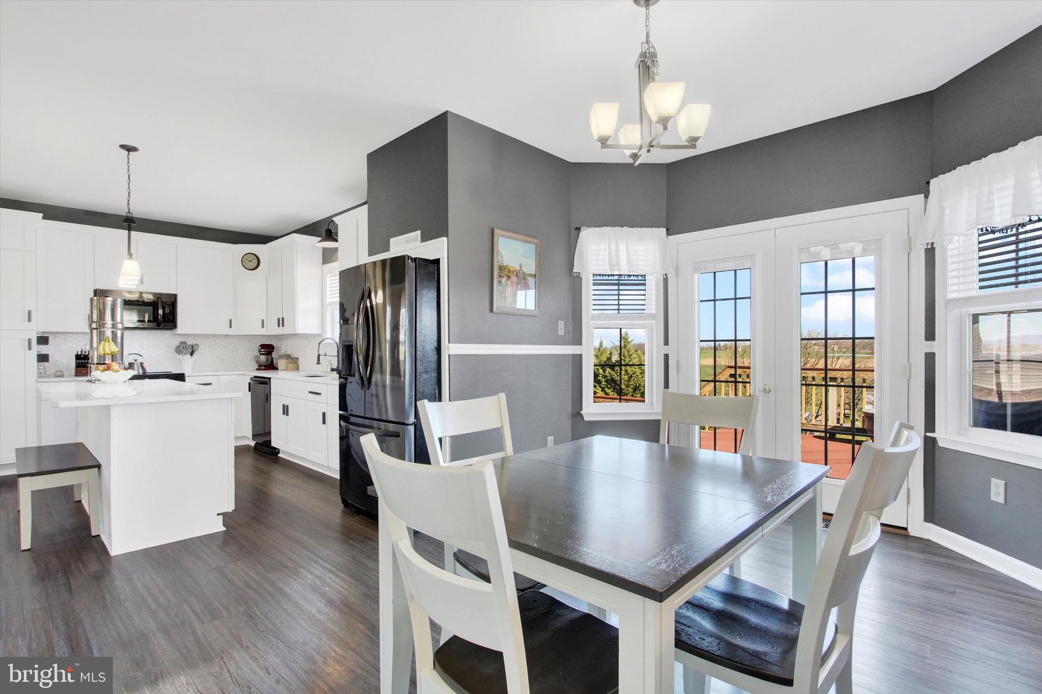 123 Colton Court Smithsburg, MD 21783 - Photo 19 of 60 a kitchen with stainless steel appliances granite countertop a refrigerator a stove a dining table and chairs with wooden floor
