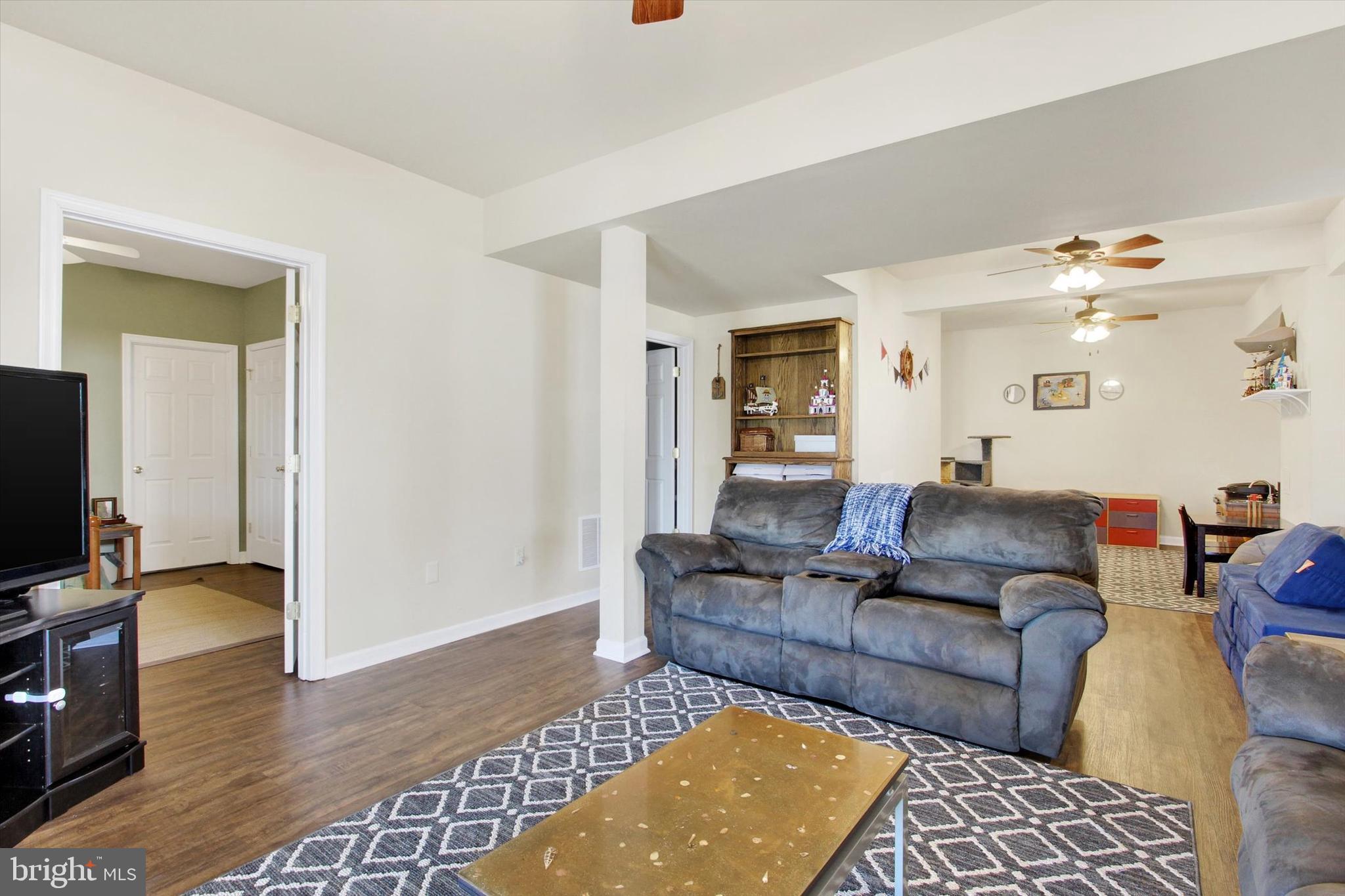 123 Colton Court Smithsburg, MD 21783 - Photo 36 of 60 a living room with furniture and a flat screen tv
