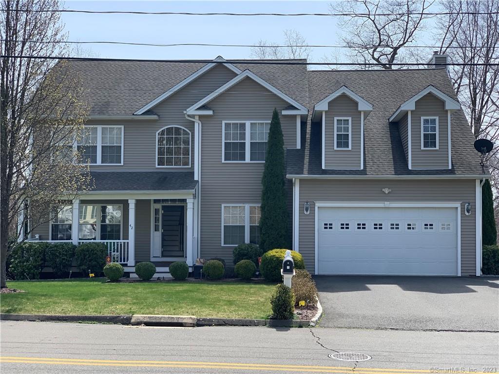 42 North Mead Farm Road Seymour, CT 06483 - Photo 1 of 1 a front view of a house with a garden and garage
