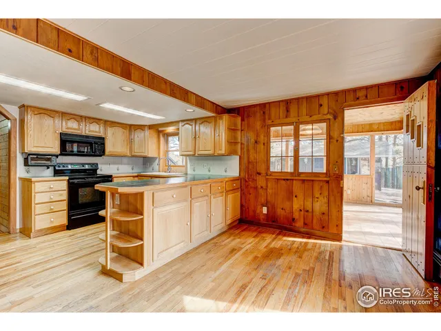 a kitchen with wooden floors and appliances