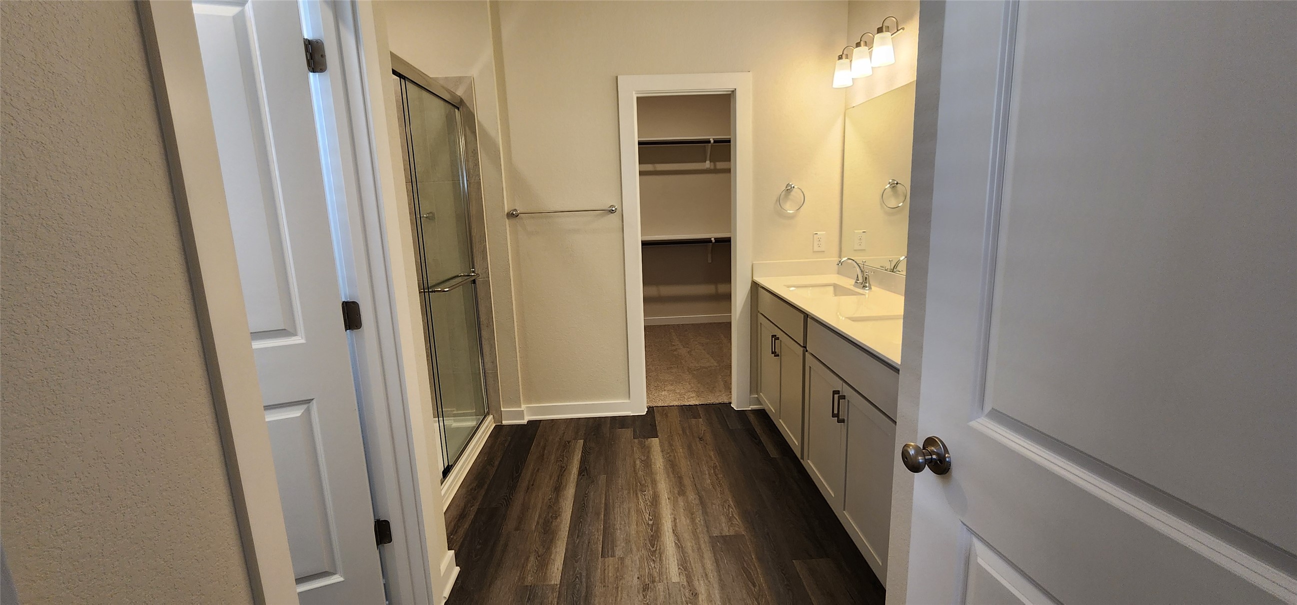 2228 Delano Drive Leander, TX 78641 - Photo 11 of 33 Full bath featuring vanity, dark wood-style floors, a shower stall, and a spacious closet