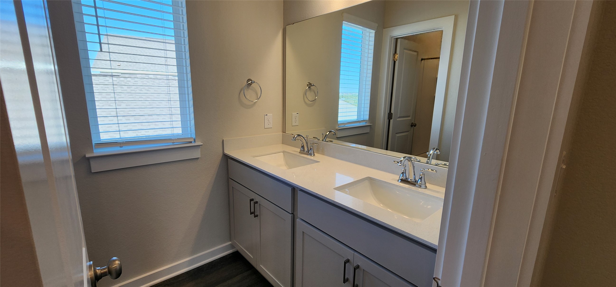 2228 Delano Drive Leander, TX 78641 - Photo 18 of 33 Full bathroom featuring double vanity and dark wood-style flooring
